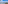 Balcony view: clear blue sea, sandy beach, distant coastal city skyline.