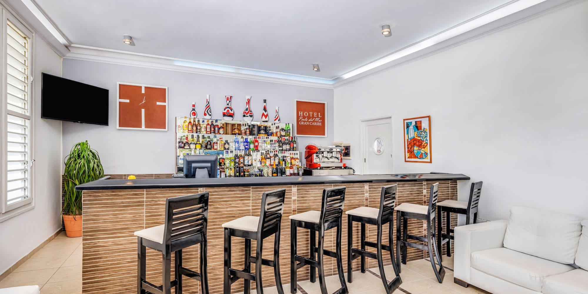 a bar with chairs and a table