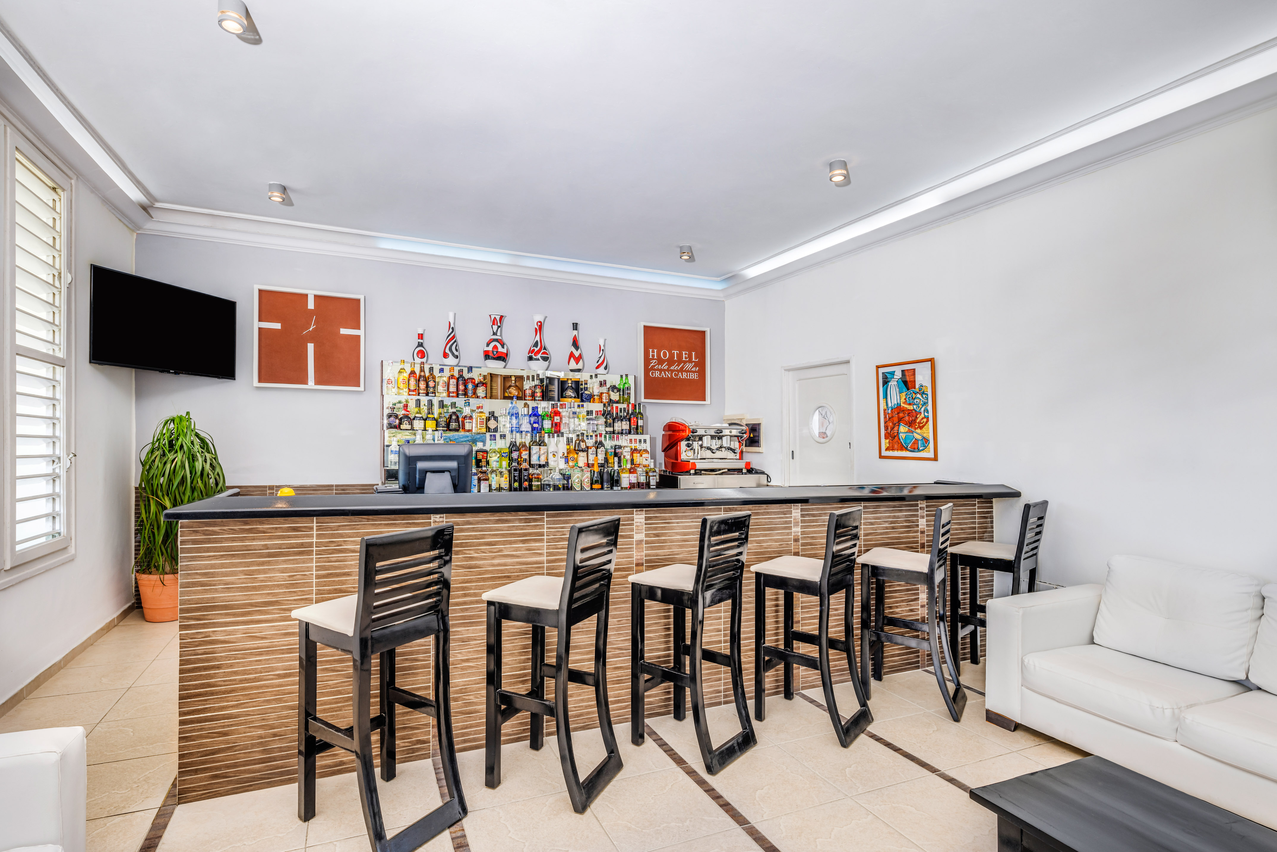 a bar with chairs and a table