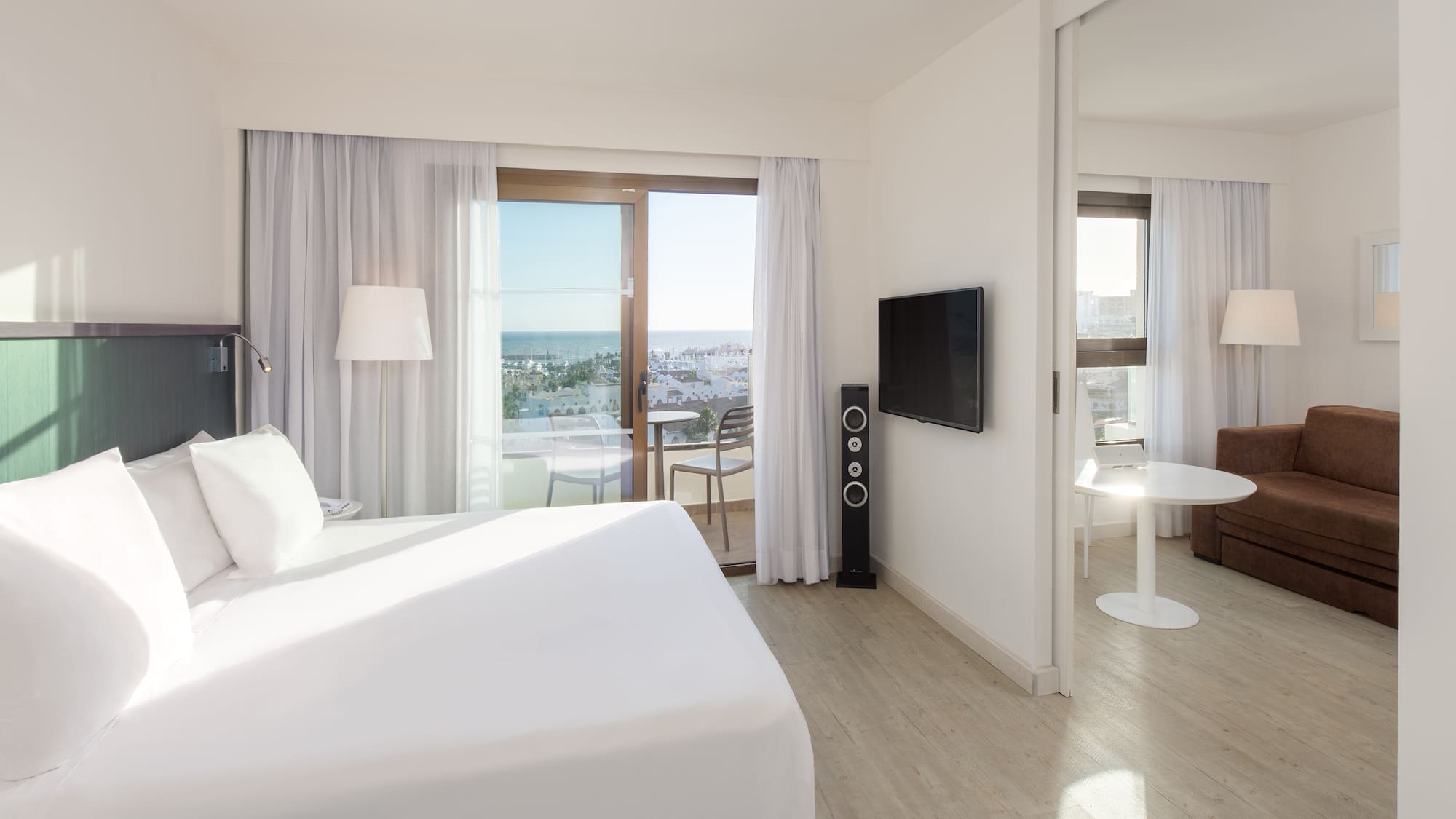 a bedroom with a large bed and a television