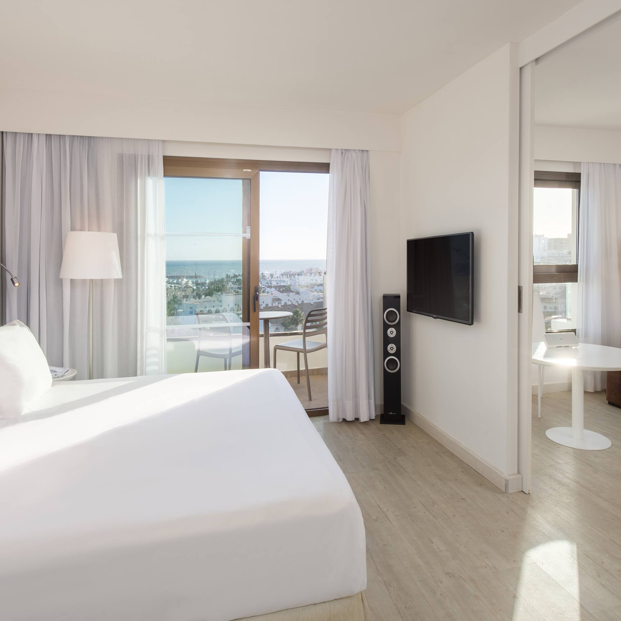 a bedroom with a large bed and a television