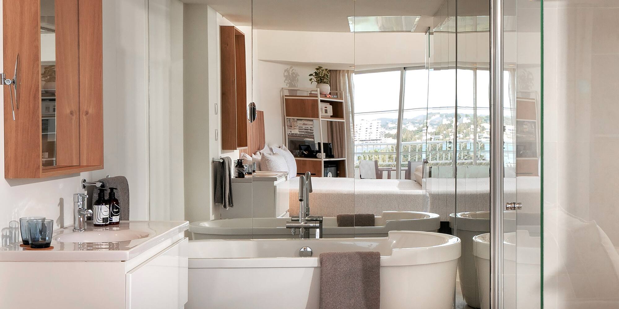 a bathroom with a large glass shower door