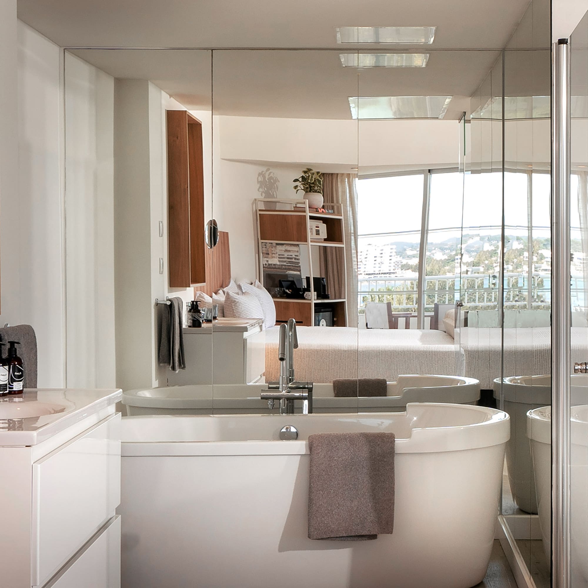 a bathroom with a large glass shower door