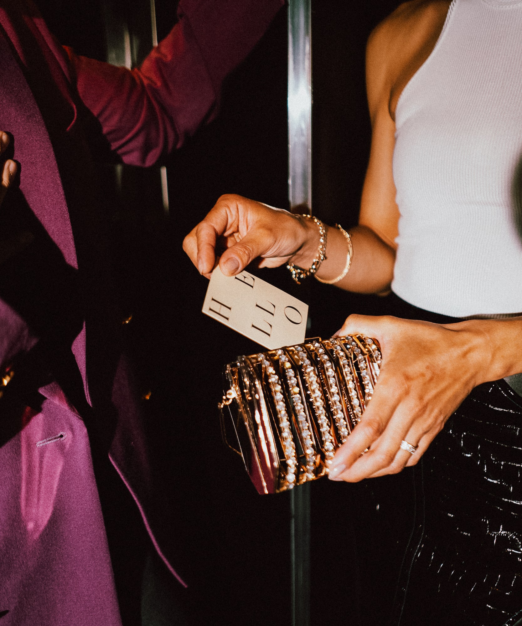 a person holding a gold purse