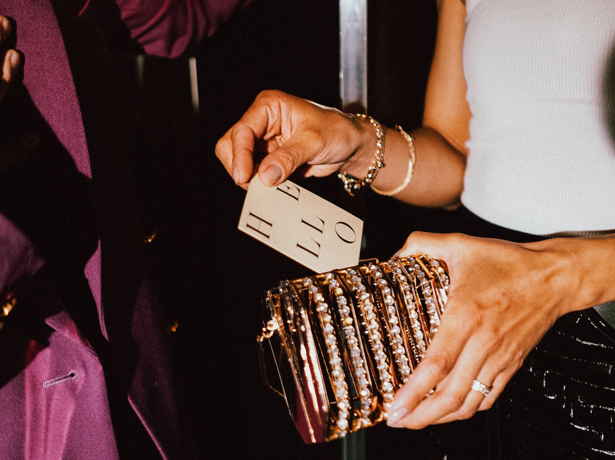 a person holding a gold purse