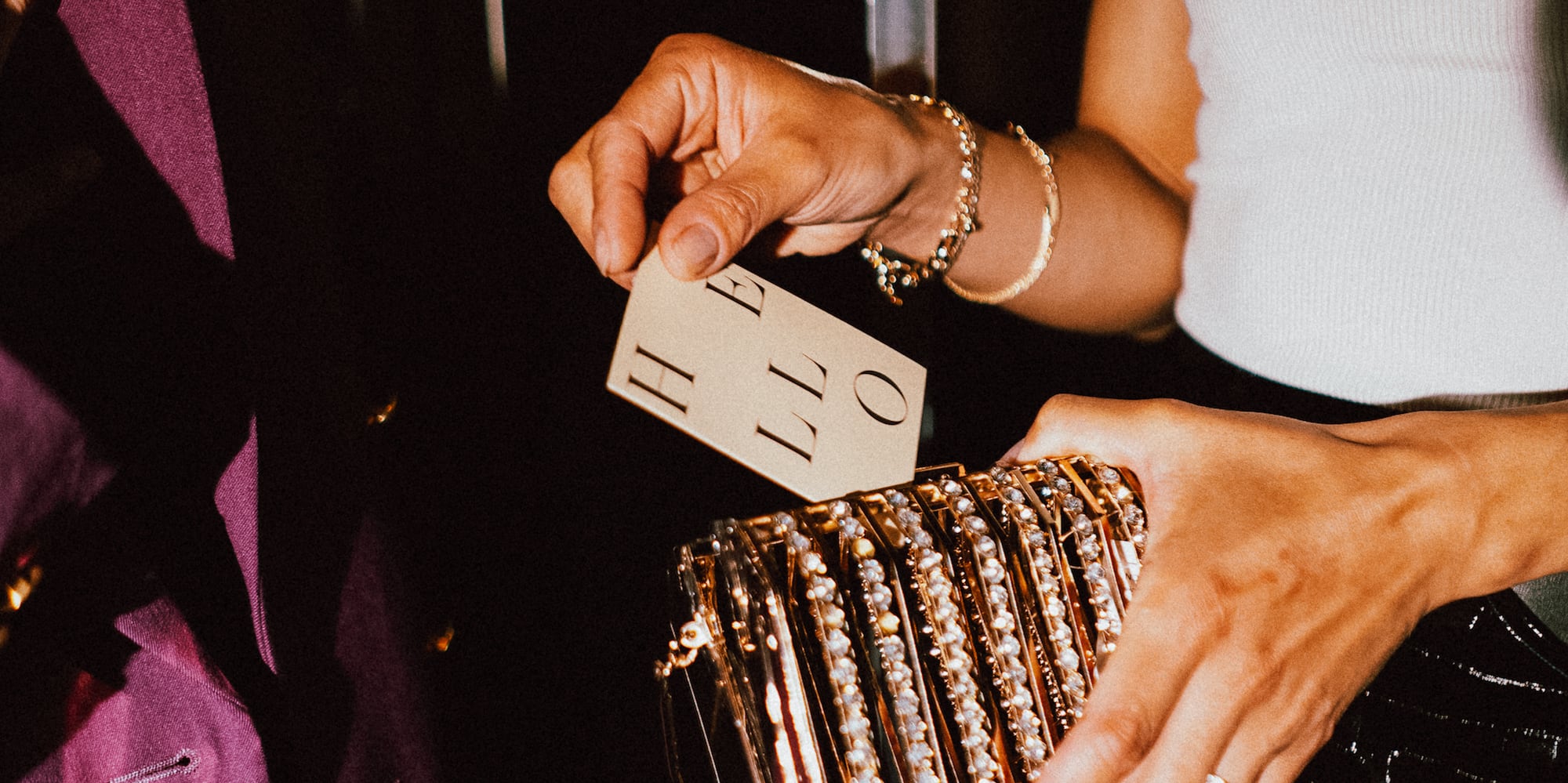 a person holding a gold purse