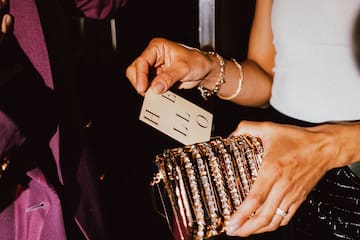 a person holding a gold purse
