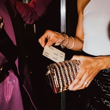 a person holding a gold purse