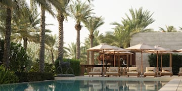 a pool with umbrellas and chairs