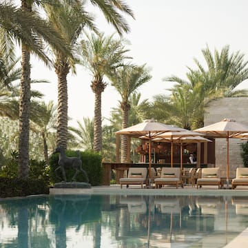 a pool with umbrellas and chairs