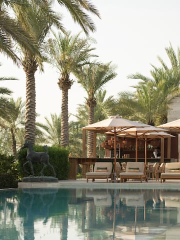 a pool with umbrellas and chairs