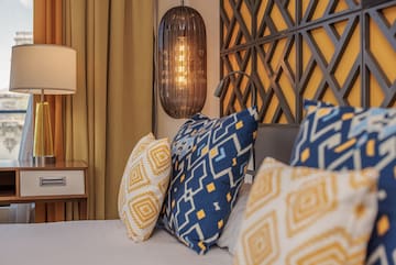 a bed with pillows and a lamp