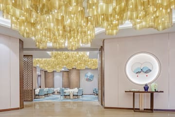 a room with a table and chairs and a painting on the ceiling