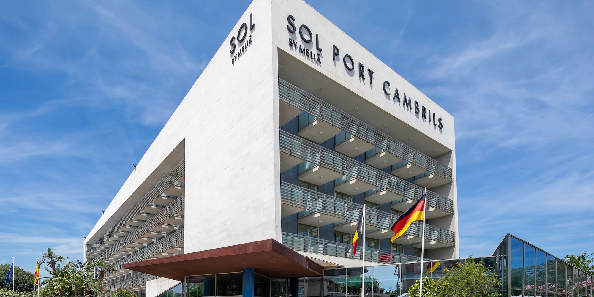 a building with flags and blue sky