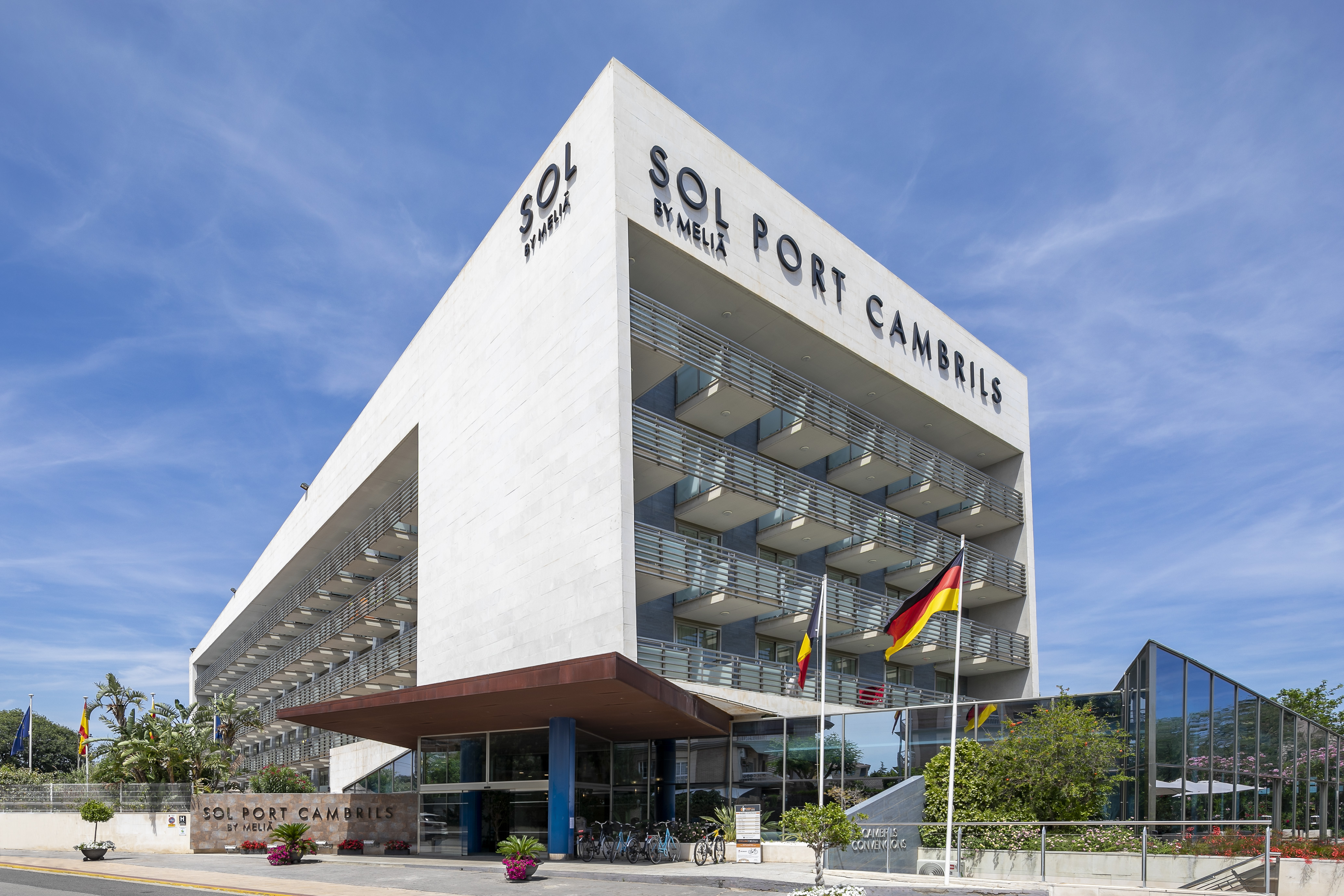 Modern Sol Port Cambrils by Meliá hotel exterior under blue sky.