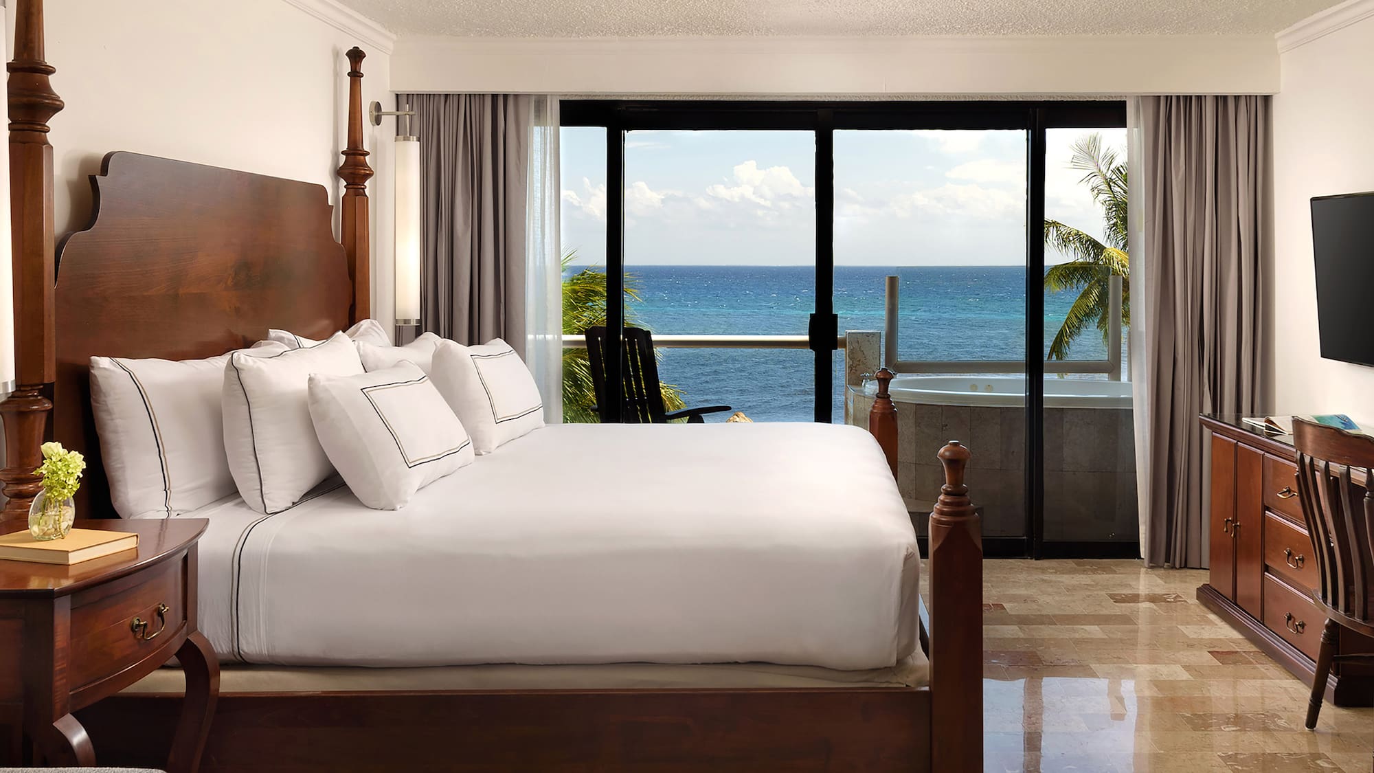 a bedroom with a large bed and a glass door