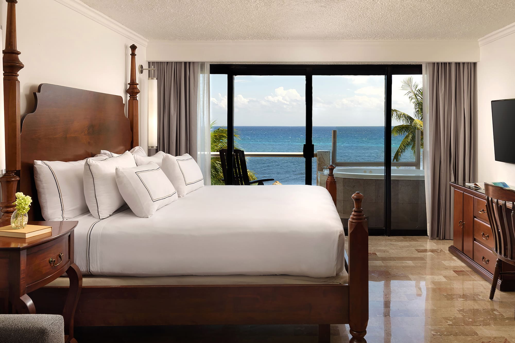 a bedroom with a large bed and a glass door