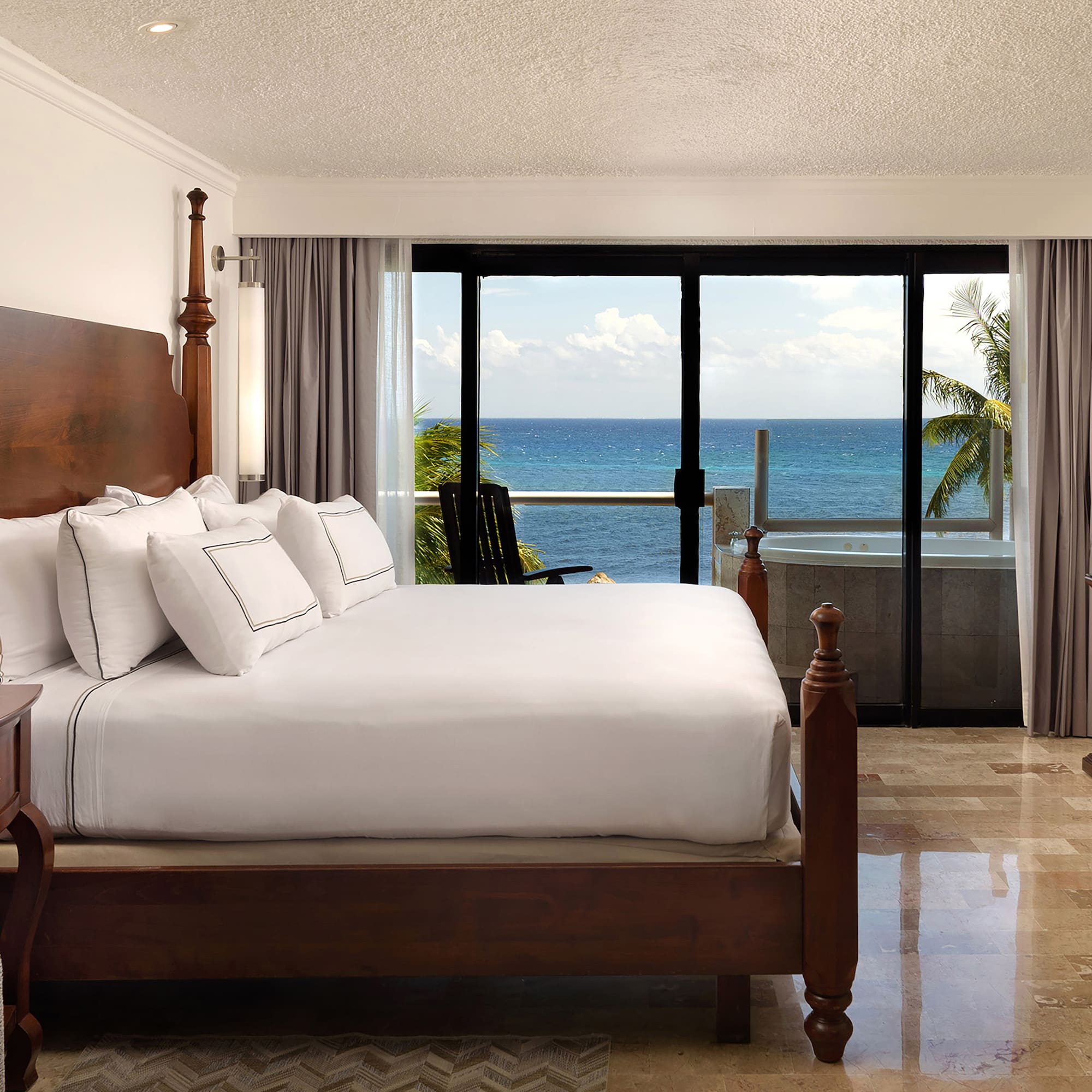 a bedroom with a large bed and a glass door