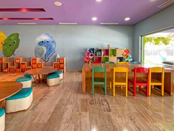 a room with colorful chairs and tables