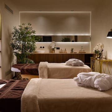 a room with beds and towels