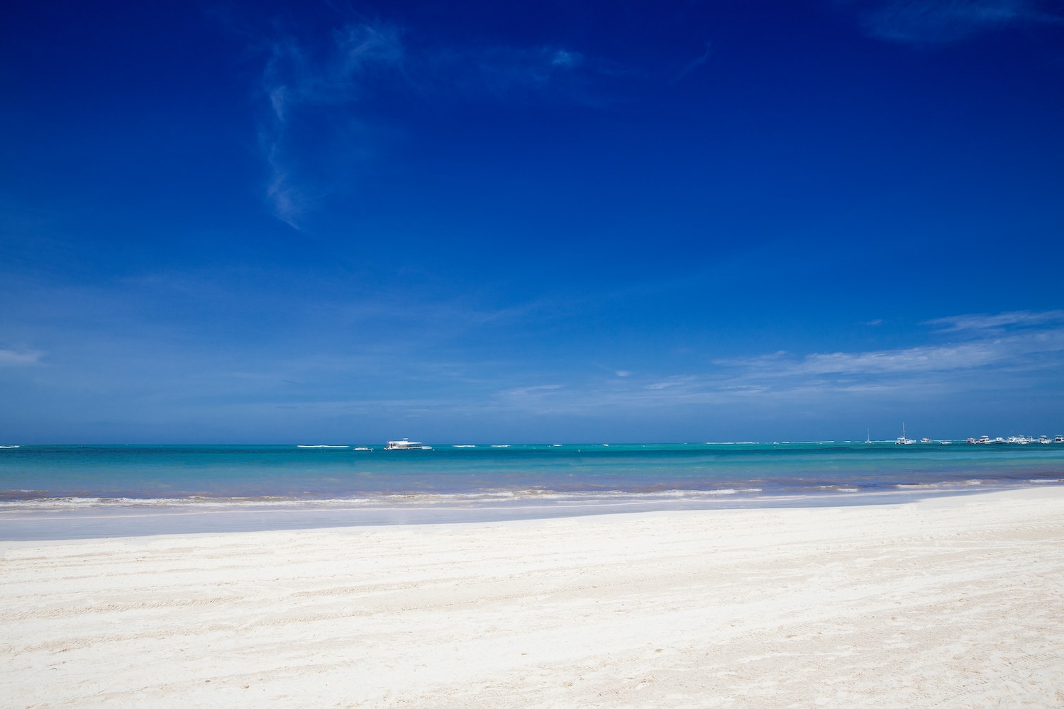 a beach with a boat in the water