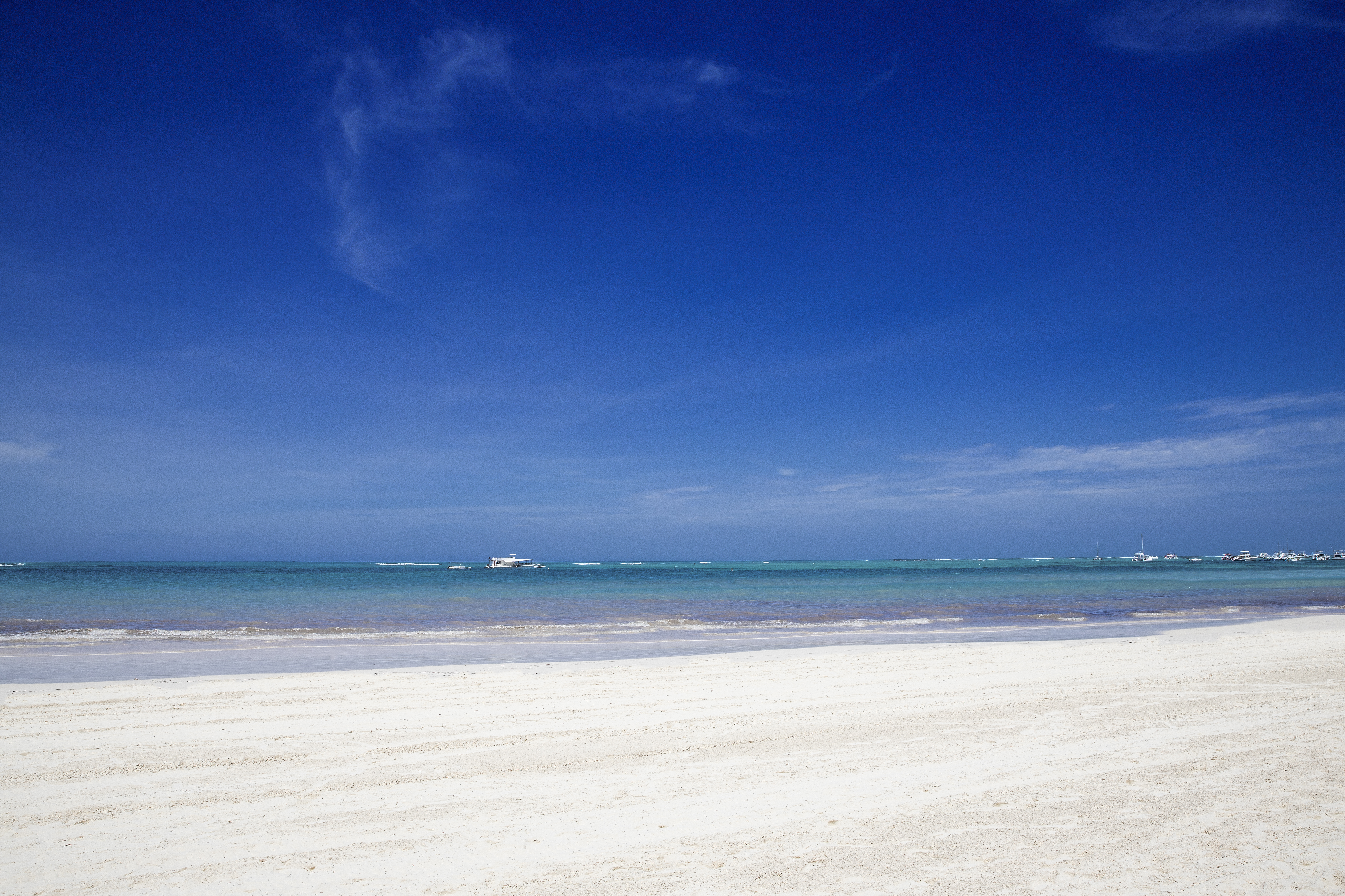a beach with a boat in the water