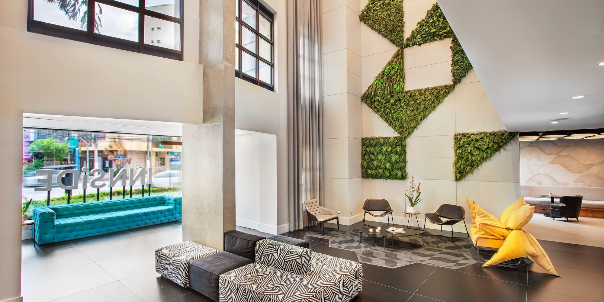 a room with a black tile floor and a yellow pillow