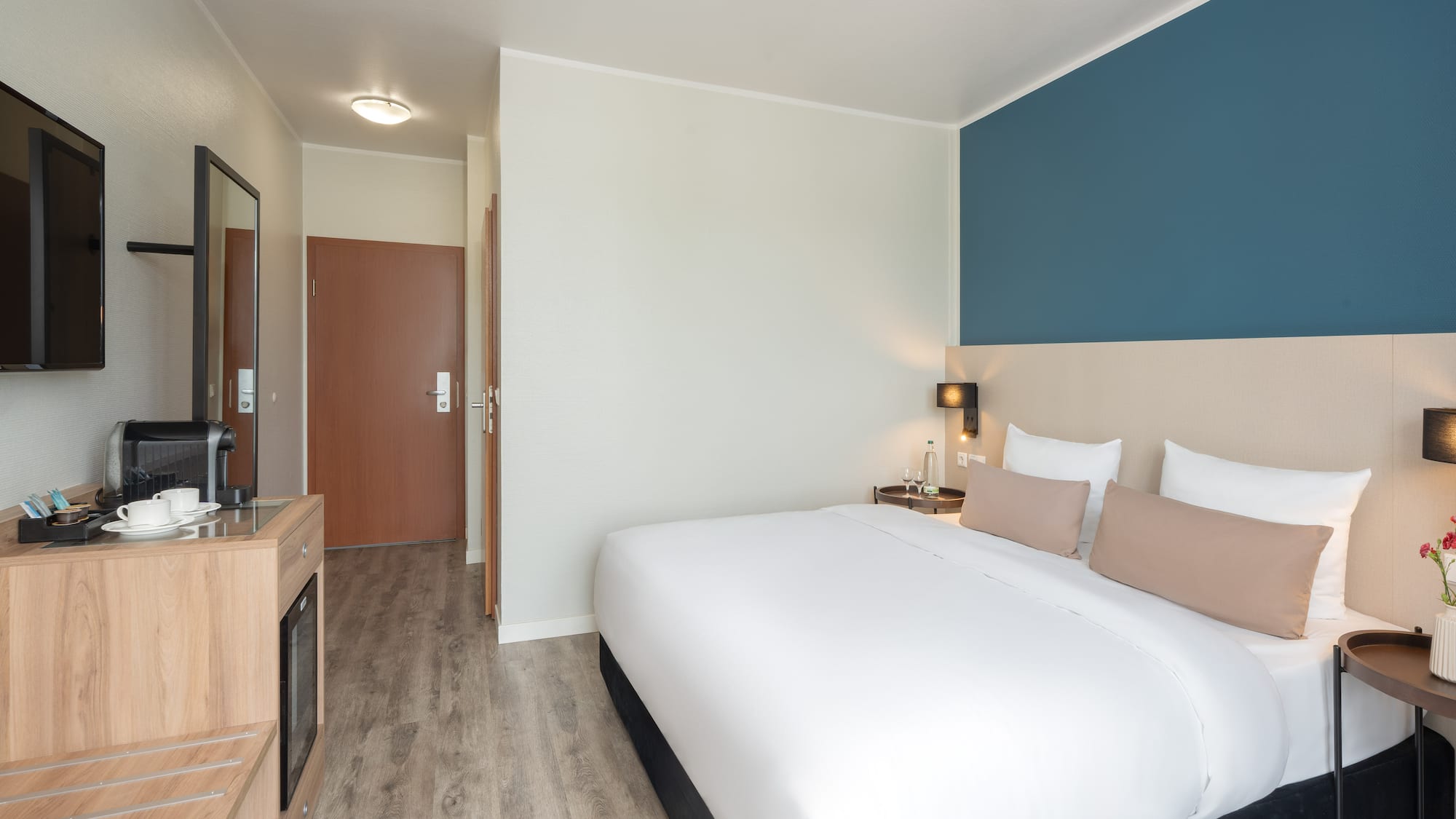 a bedroom with a bed and a tv