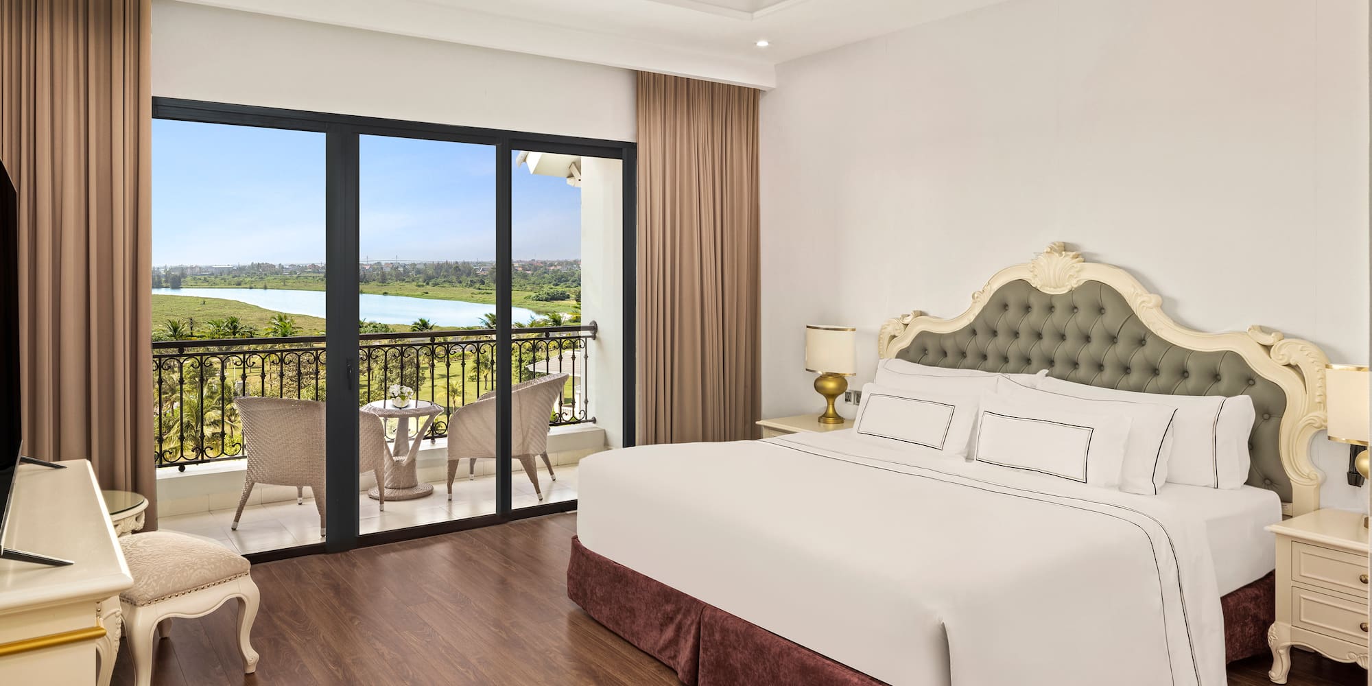 a bedroom with a balcony and a view of the river