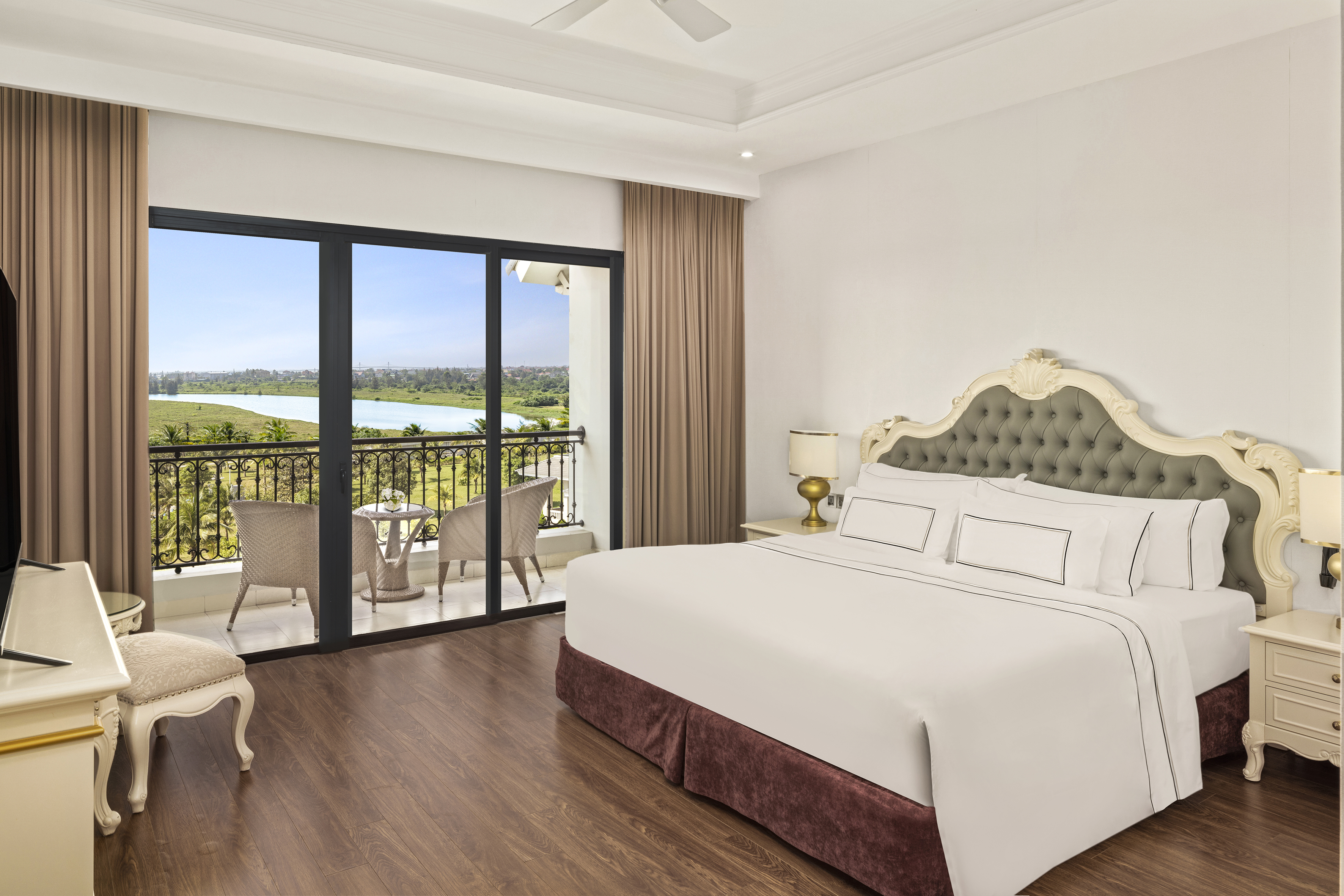 a bedroom with a balcony and a view of the river