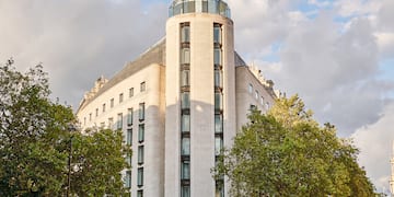 a group of people walking around a building