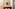 Elegant bathroom with travertine tiles, wood vanity, round mirror, and shower.