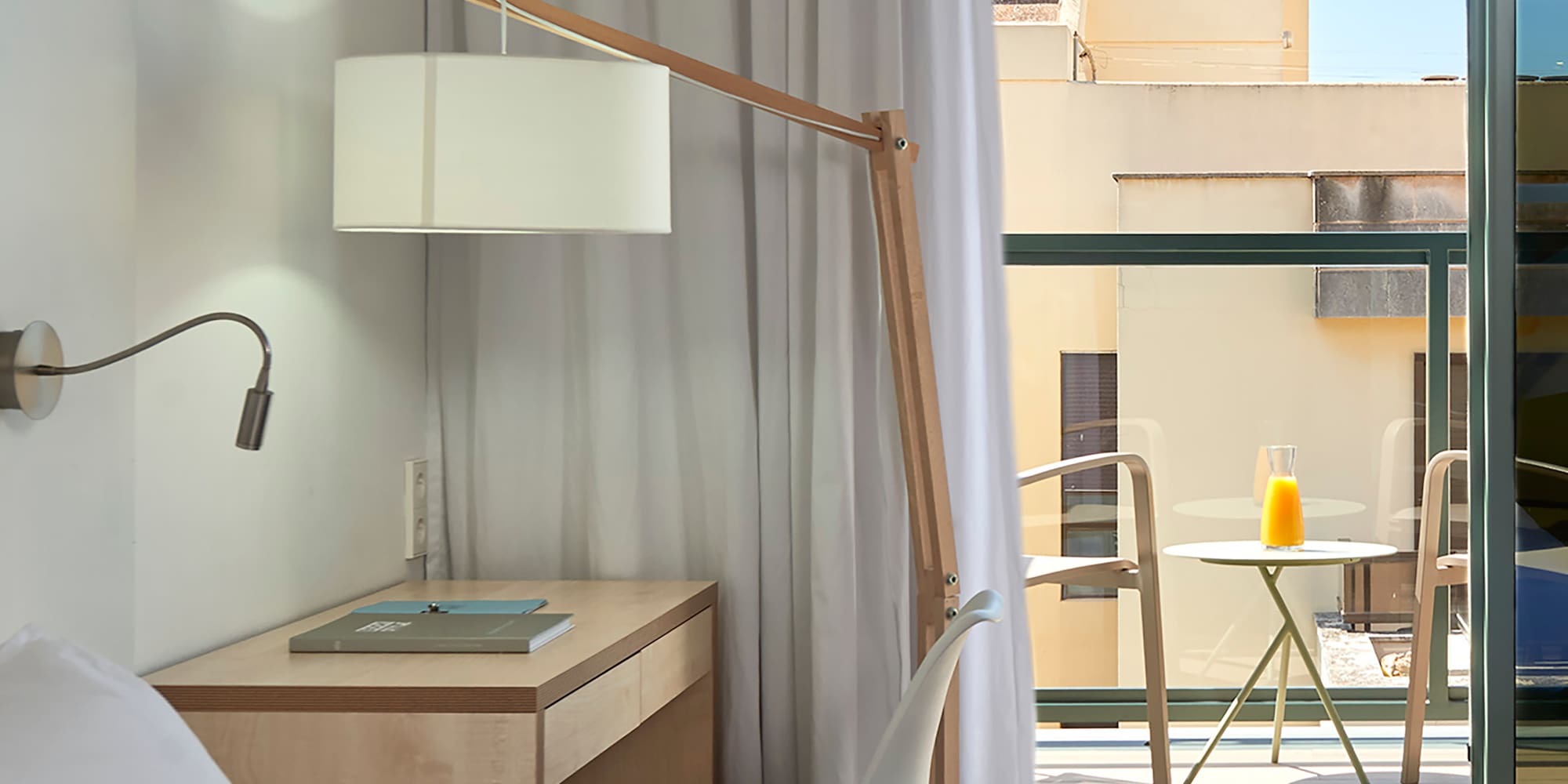 a bedroom with a desk and a lamp