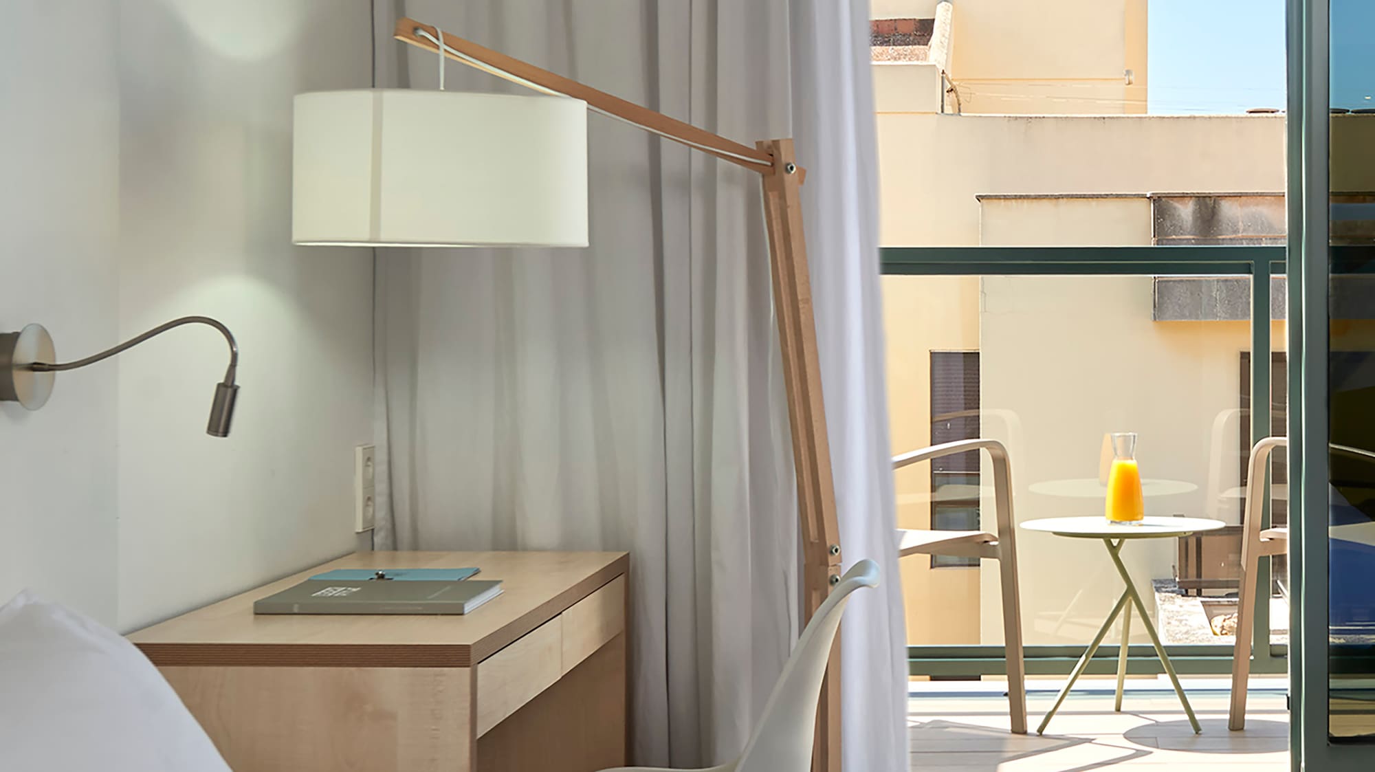 a bedroom with a desk and a lamp