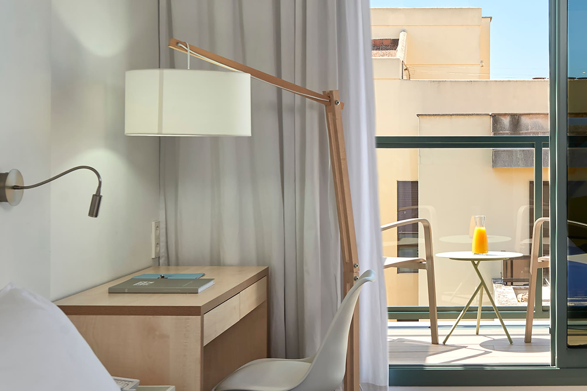 a bedroom with a desk and a lamp