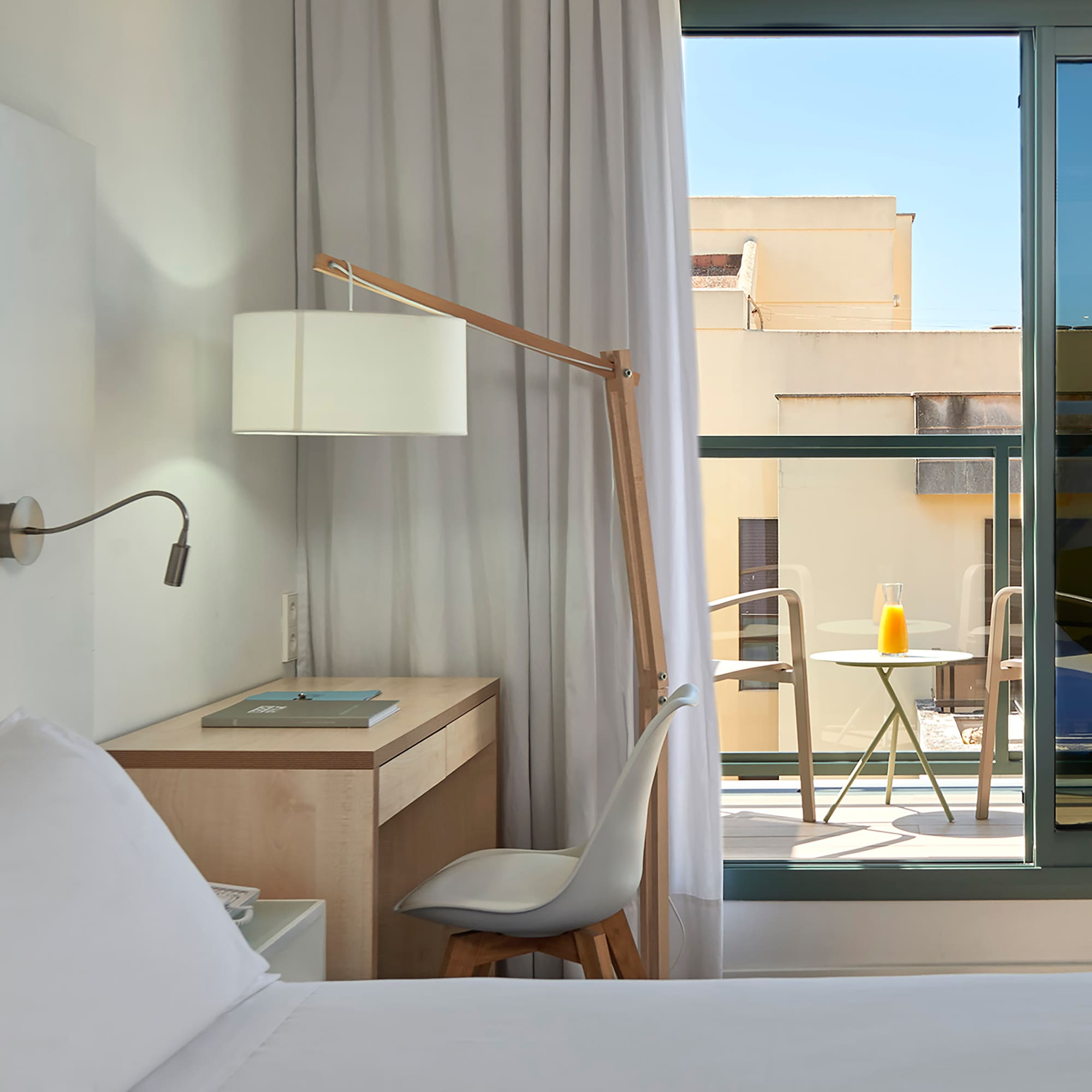 a bedroom with a desk and a lamp