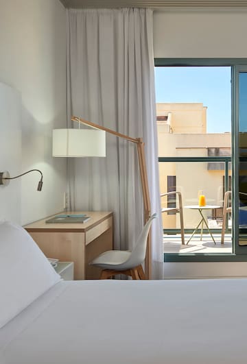 a bedroom with a desk and a lamp