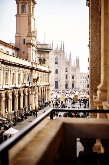 a group of people walking in a courtyard