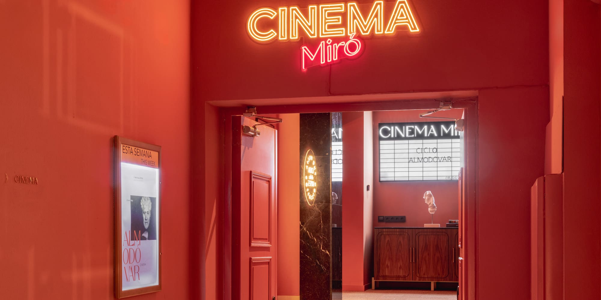 a red wall with a sign