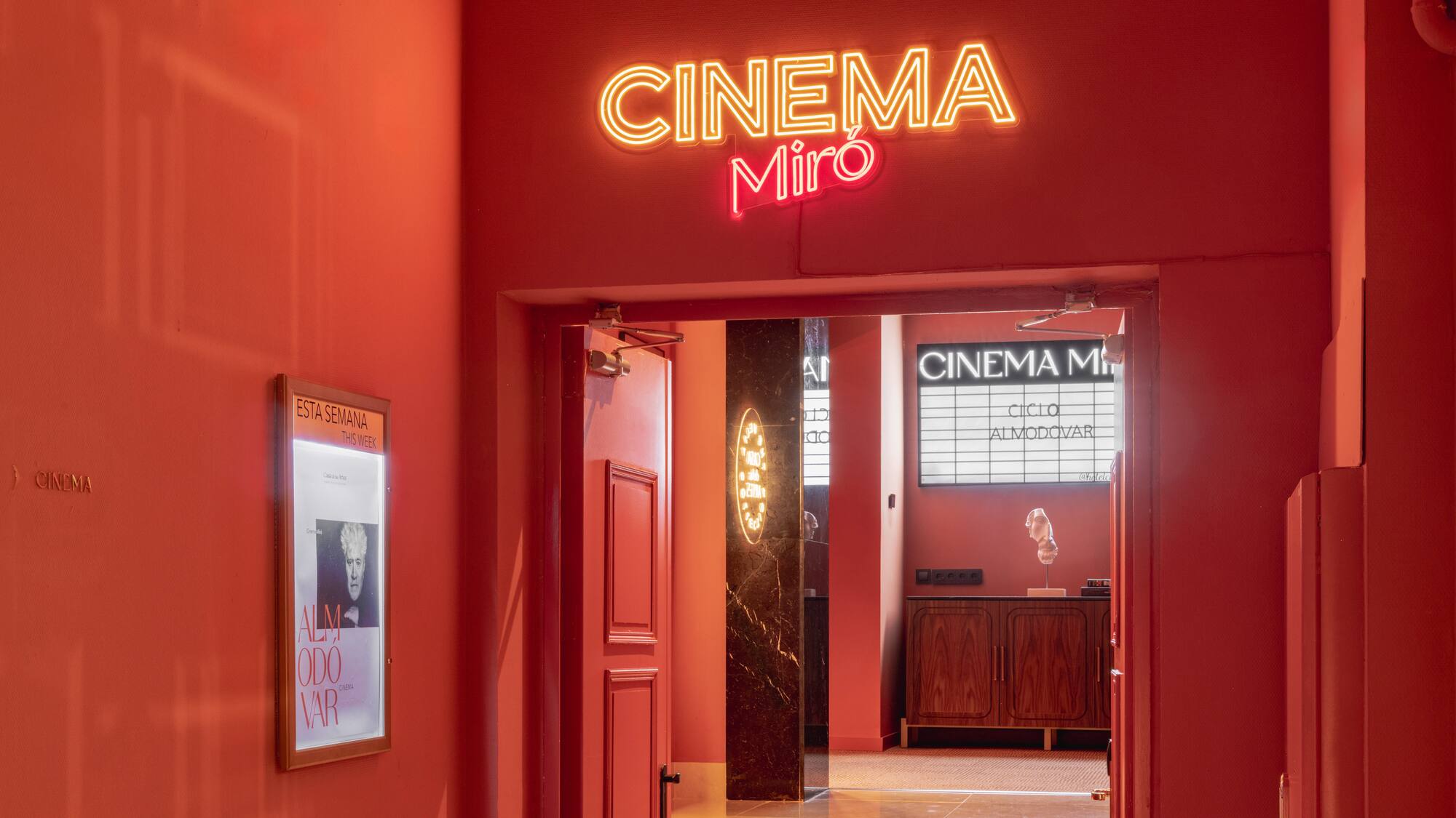 Red Cinema Miró entrance, bright neon sign, Almodóvar film cycle.