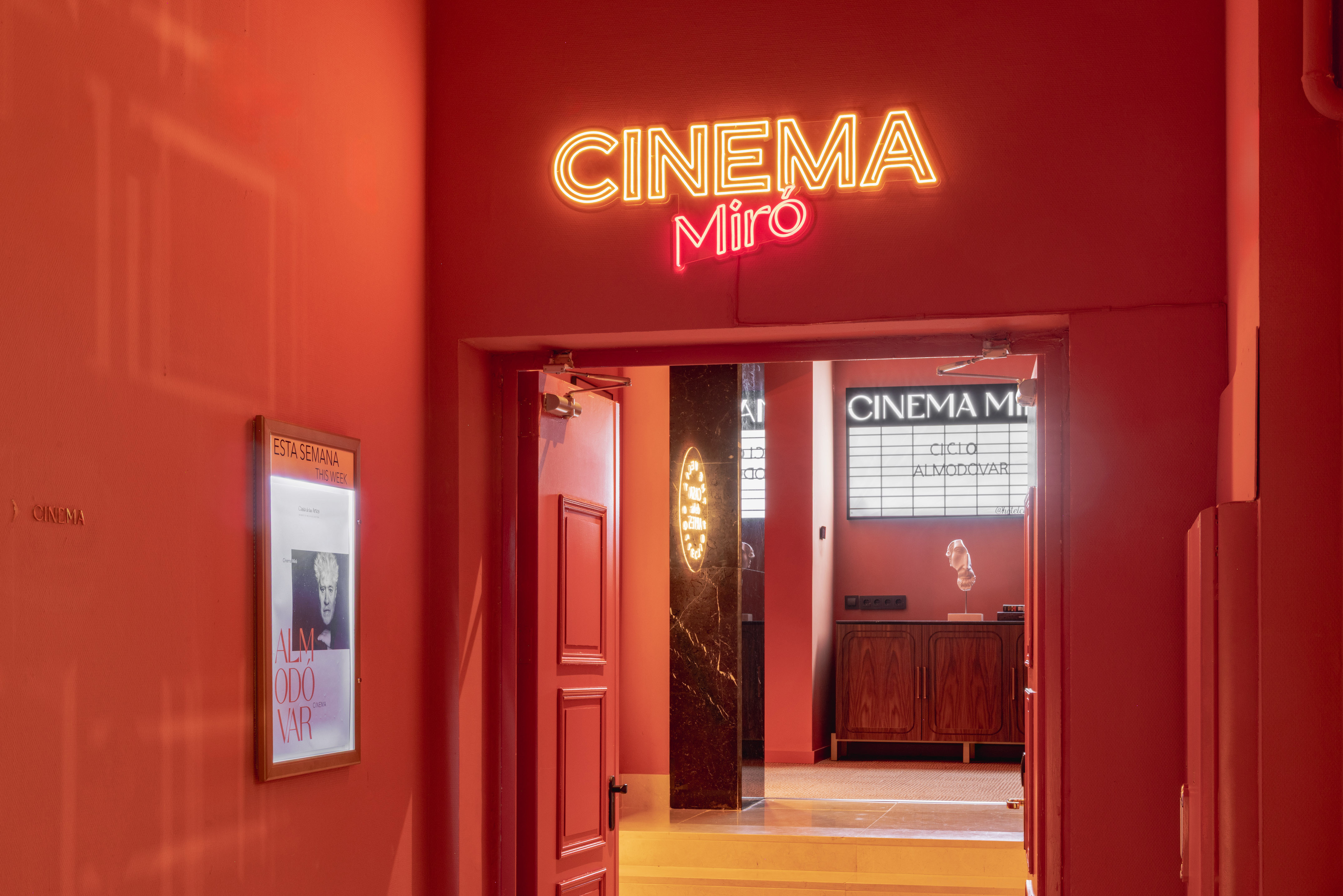 Red Cinema Miró entrance, bright neon sign, Almodóvar film cycle.