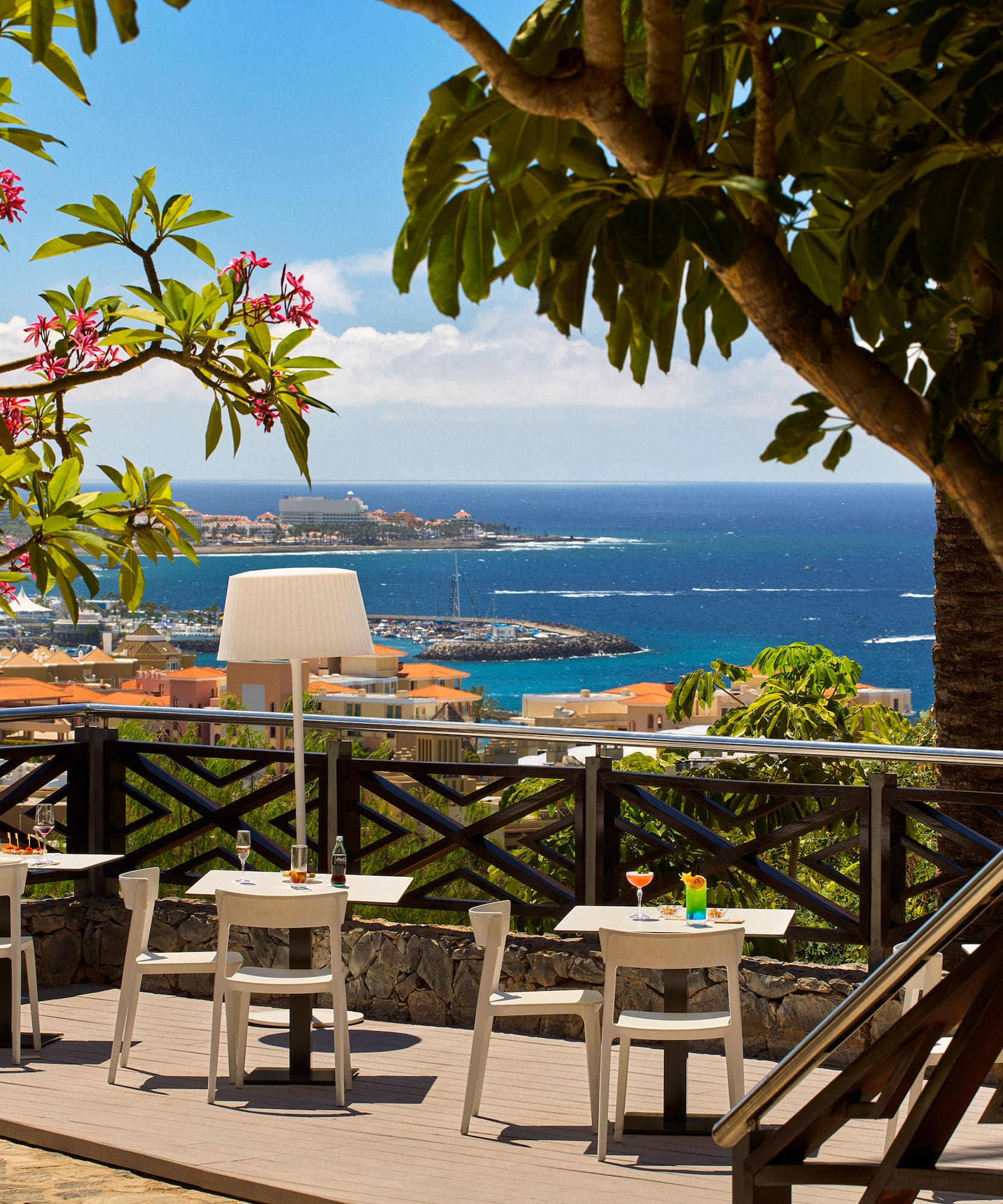 a table and chairs on a deck overlooking a body of water