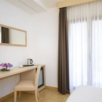 a room with a desk chair and a mirror