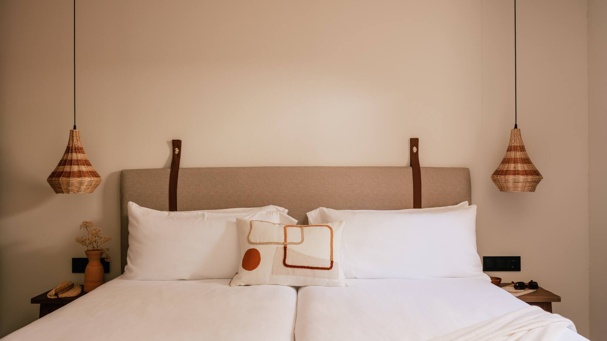 a bed with pillows and lamps