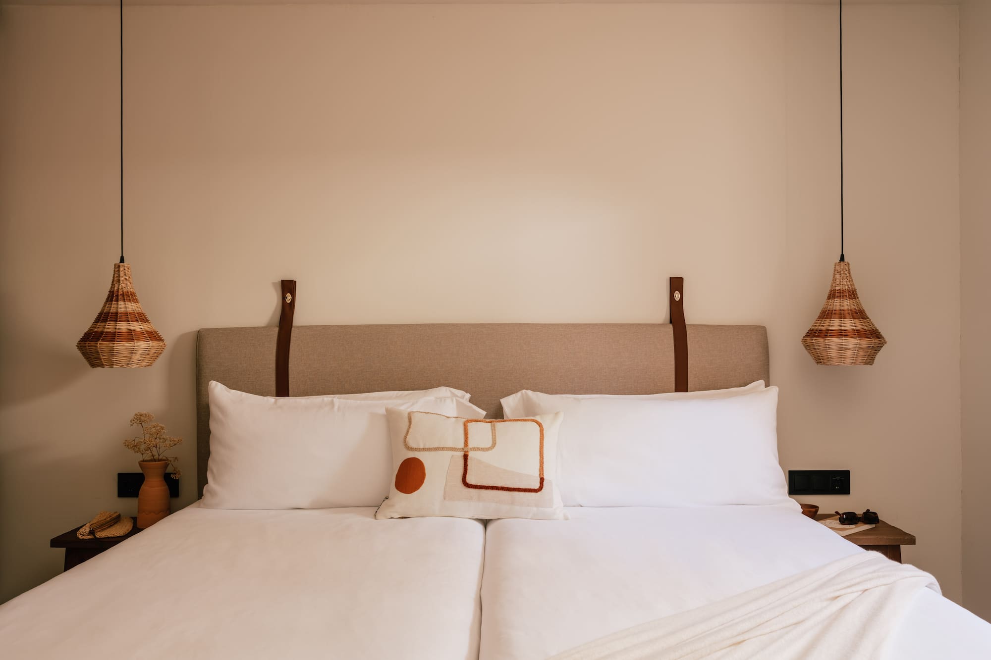 a bed with pillows and lamps