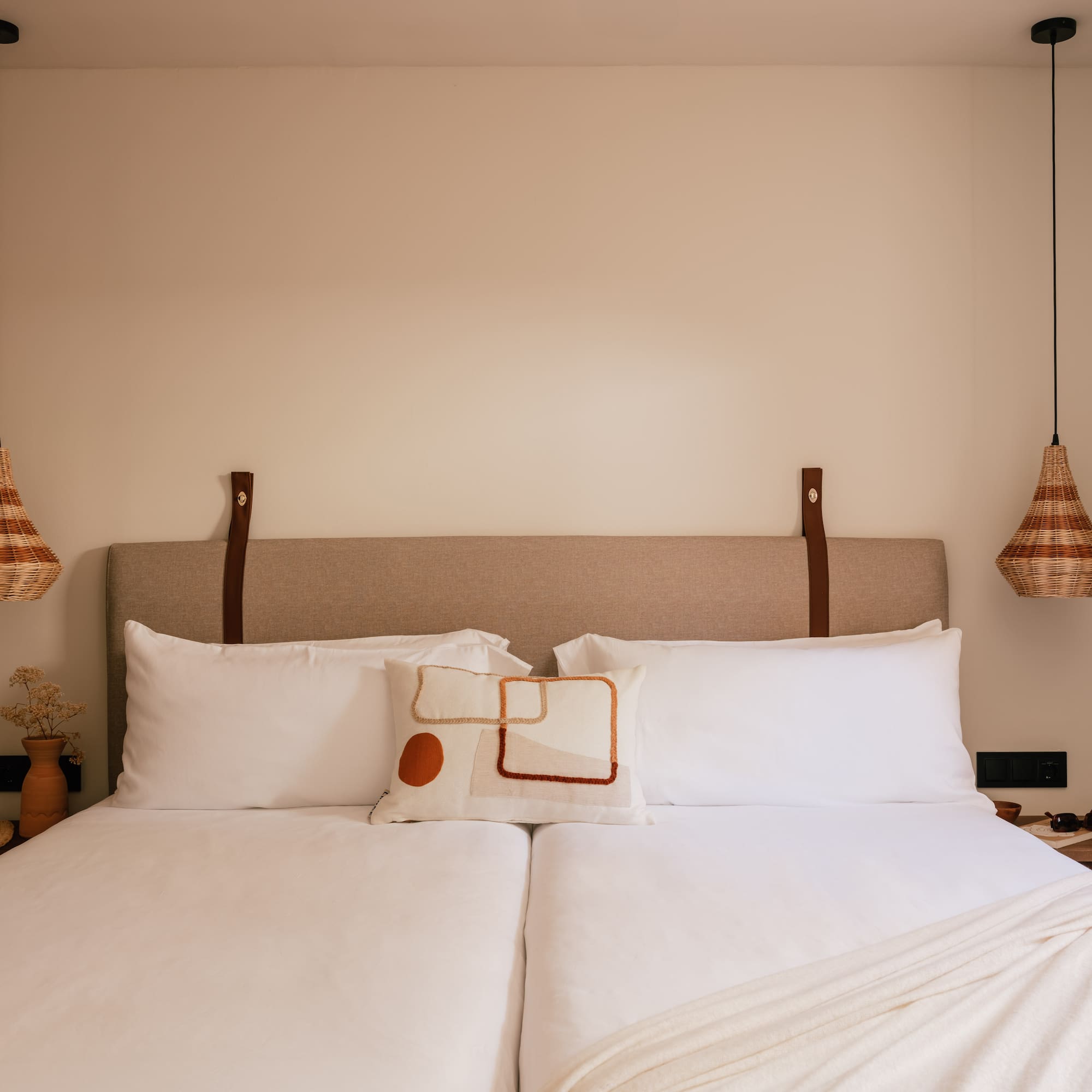 a bed with pillows and lamps