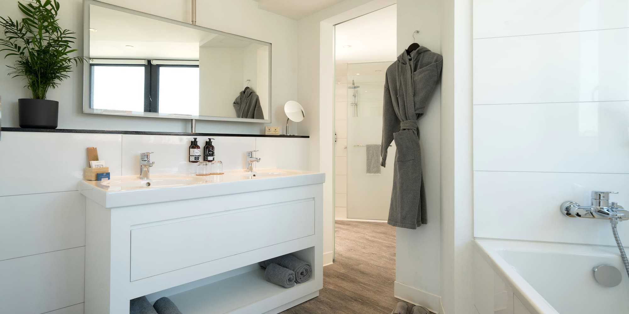 a bathroom with a bathrobe and a bathtub