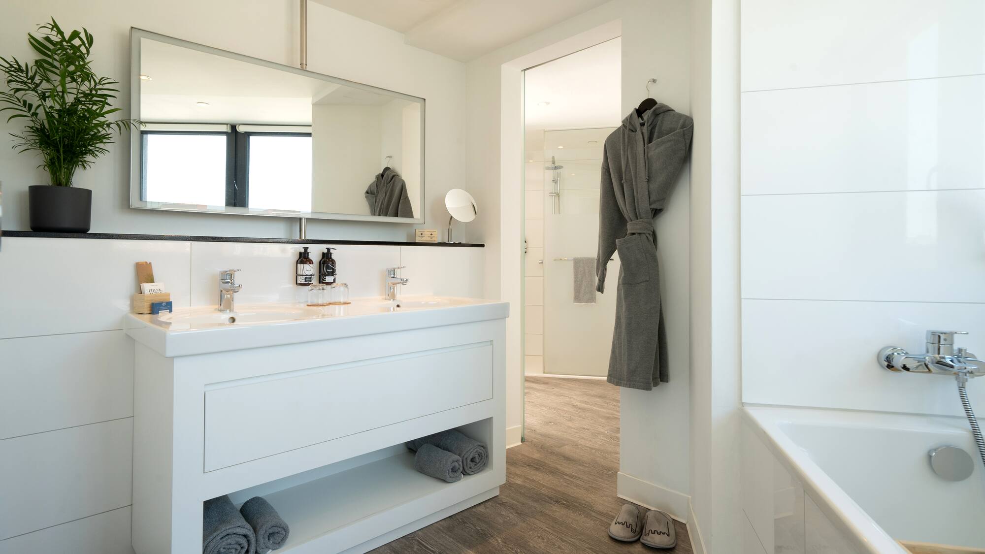 a bathroom with a bathrobe and a bathtub