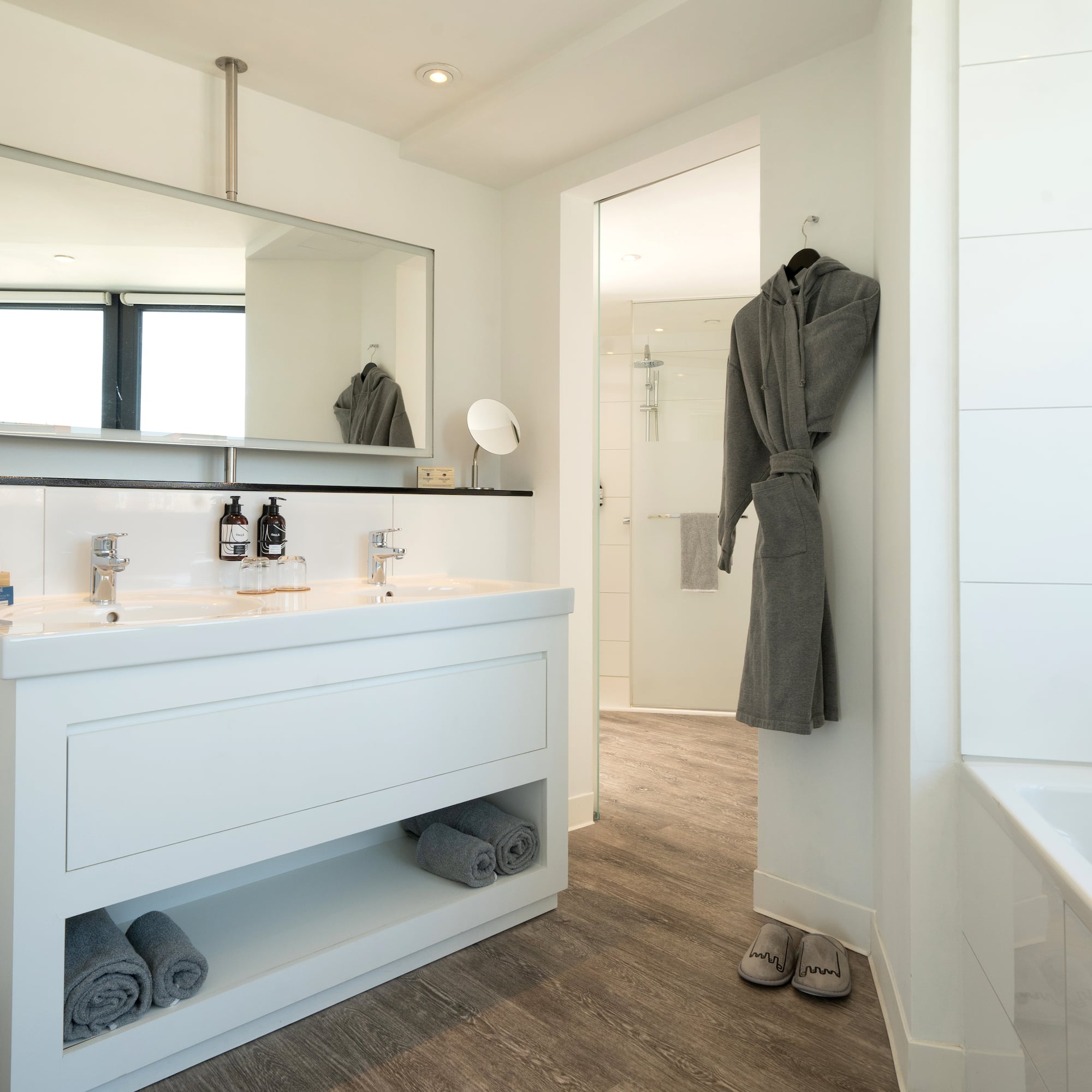 a bathroom with a bathrobe and a bathtub
