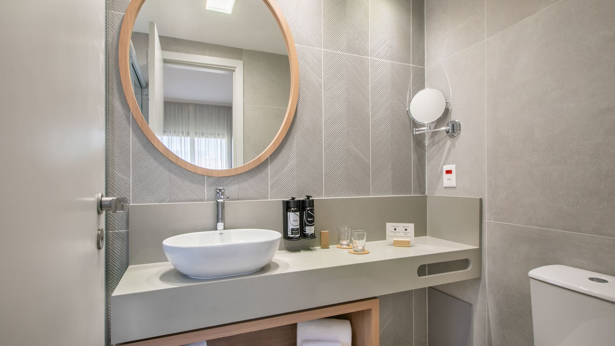 a bathroom with a round mirror